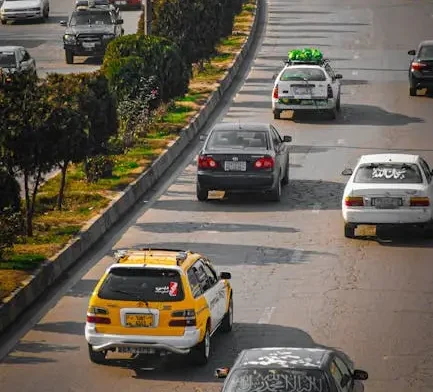 A bustling scene of cars driving on a major street in Kabul, Afghanistan.